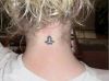 libra sign tattoo on back of neck